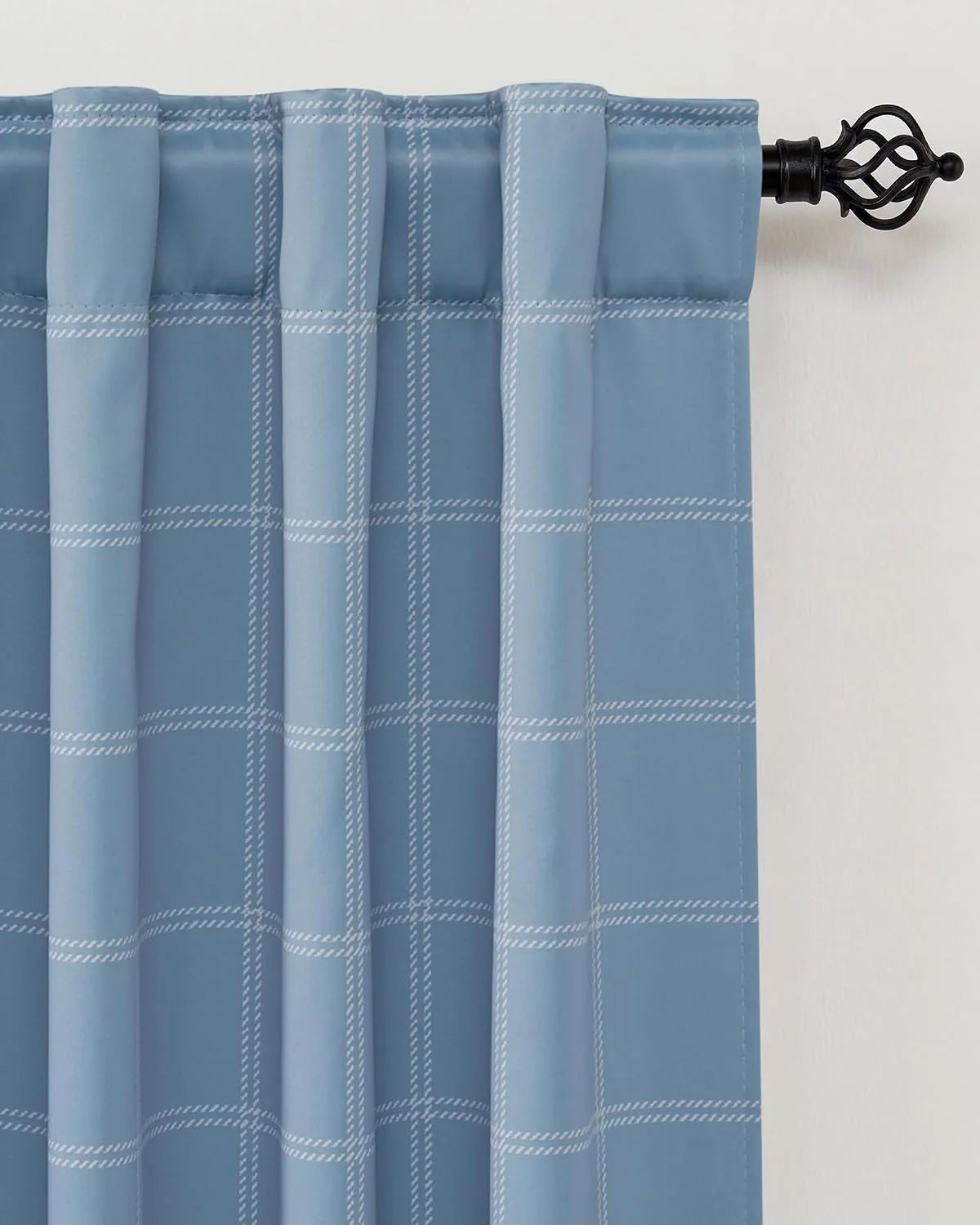 Light blue windowpane curtain panel with rod pocket on a black decorative curtain rod