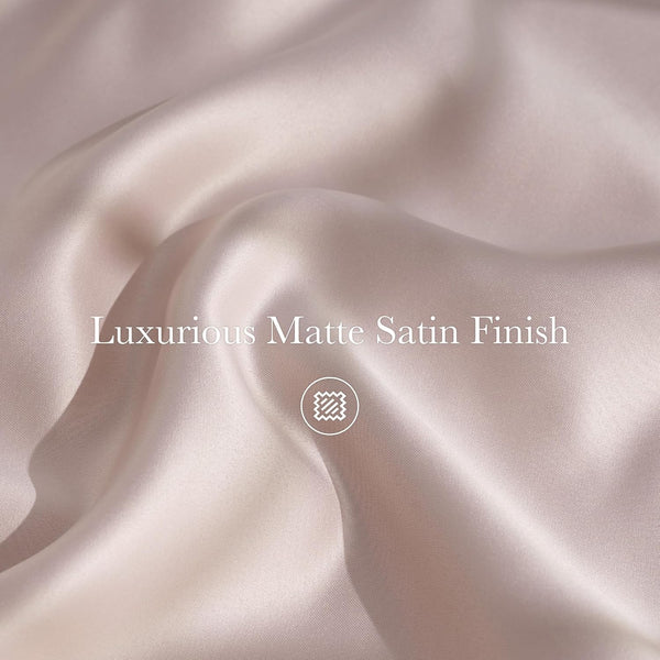 Close-up of luxurious blush matte satin fabric showing elegant drapes and a smooth, soft finish.