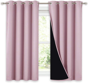 Blush pink blackout curtains with silver grommet tops hanging on a rod. The right panel shows the dark black lining.
