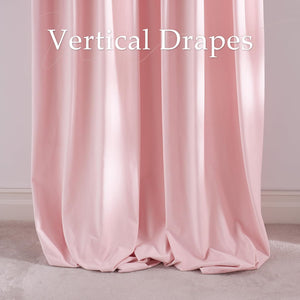Elegant blush pink vertical drapes with gentle folds, pooling at the bottom on a light carpet.