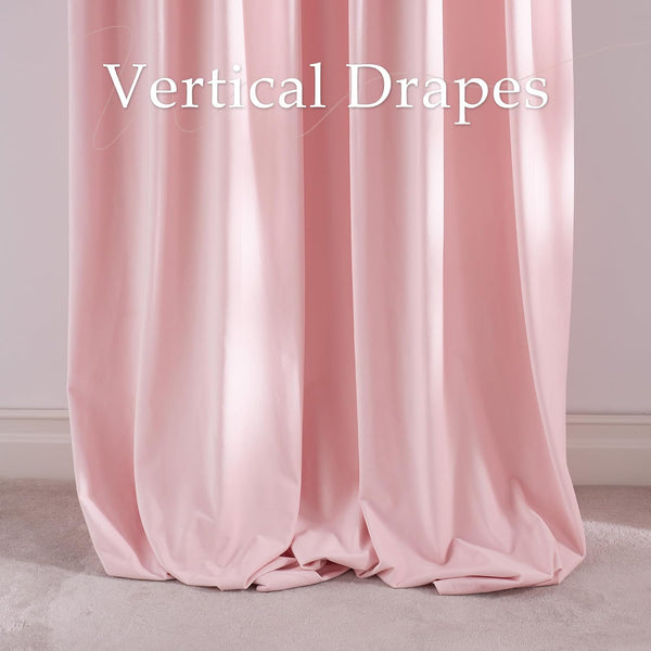 Elegant blush pink vertical drapes with gentle folds, pooling at the bottom on a light carpet.