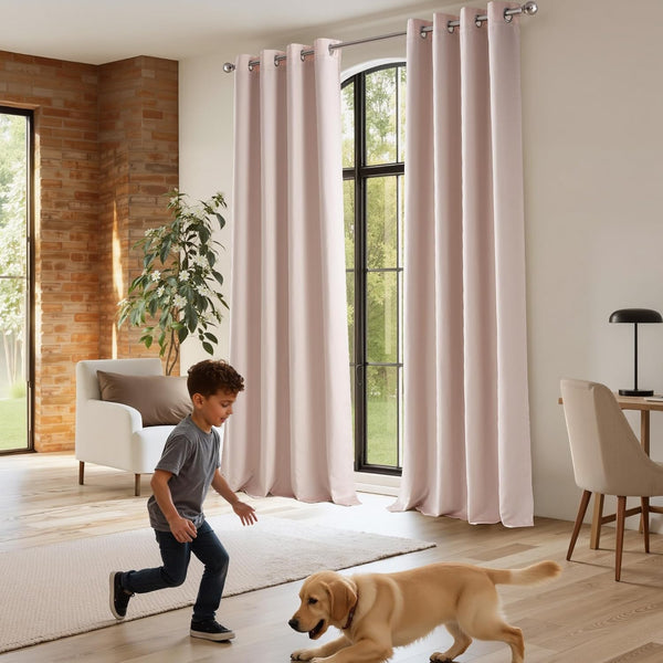 Blush pink linen-look grommet curtains hanging on a silver rod over large arched windows in a modern living room.