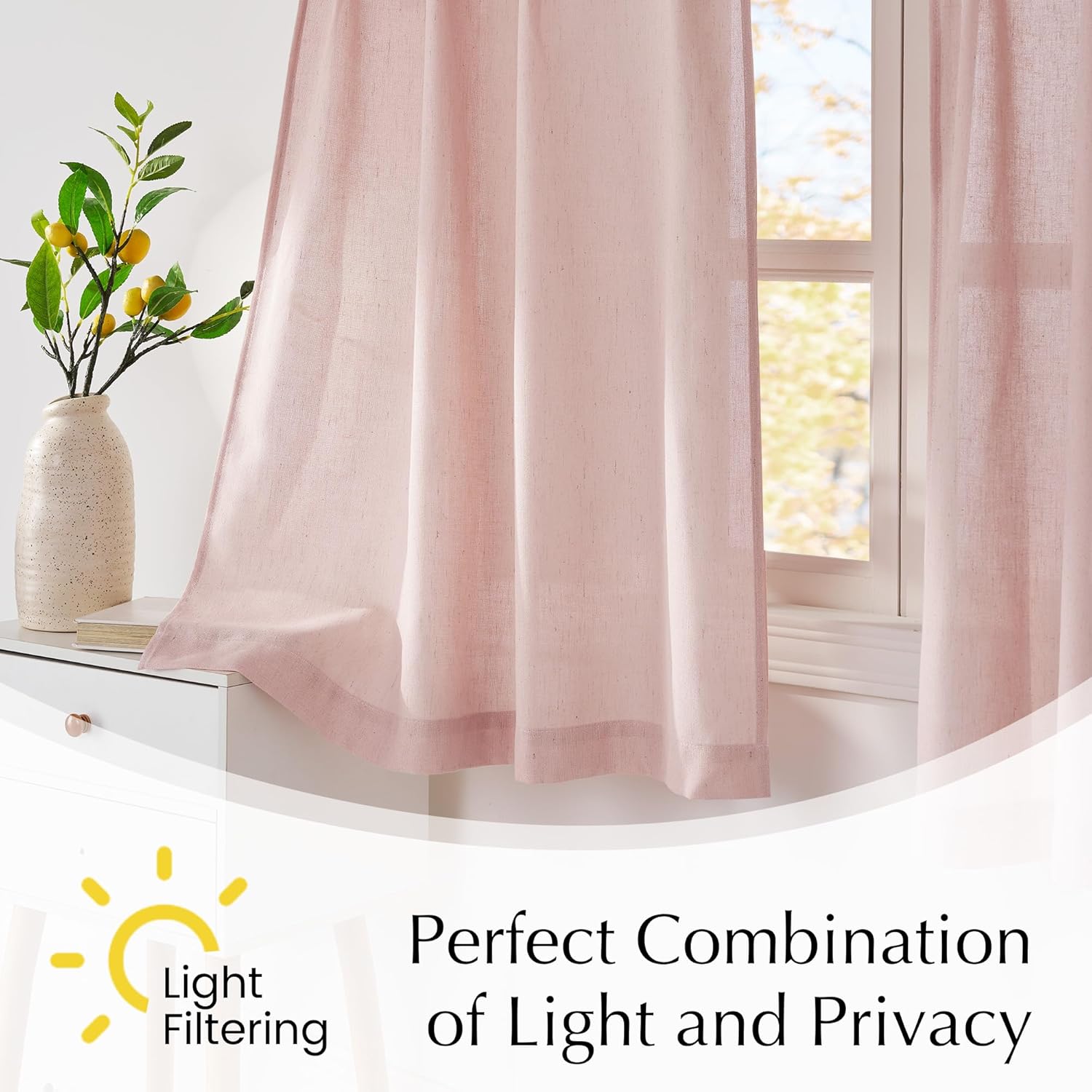 Blush pink light filtering linen curtains hanging by a window, providing privacy and soft natural light.