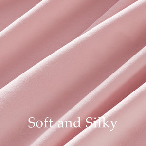 Close-up of blush pink flowing fabric, showcasing its soft, subtle texture.