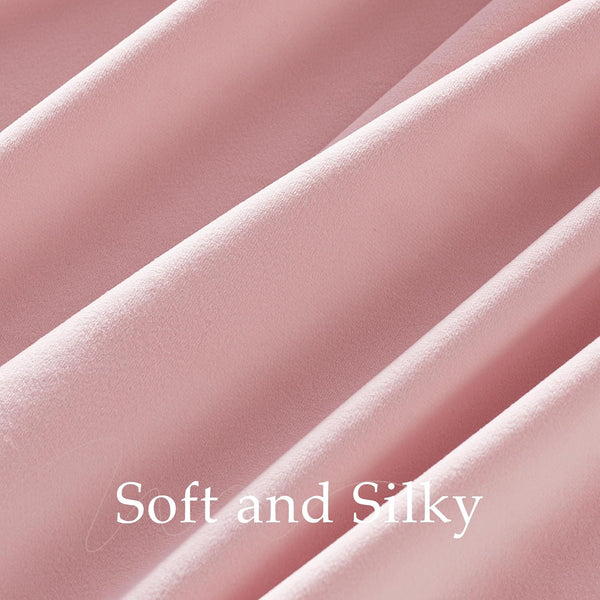 Close-up of blush pink flowing fabric, showcasing its soft, subtle texture.