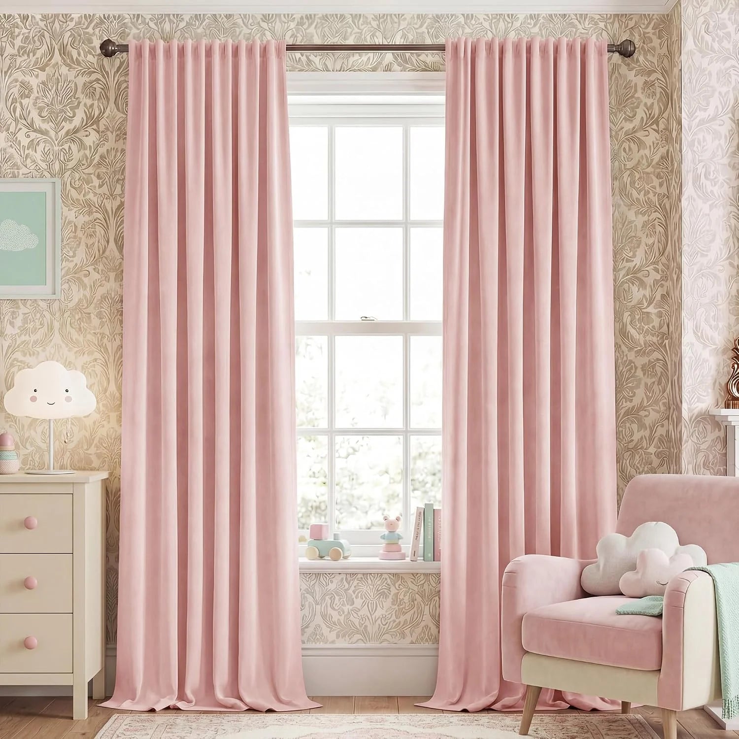 Blush pink velvet curtains hanging on a rod in a soft pastel children's room