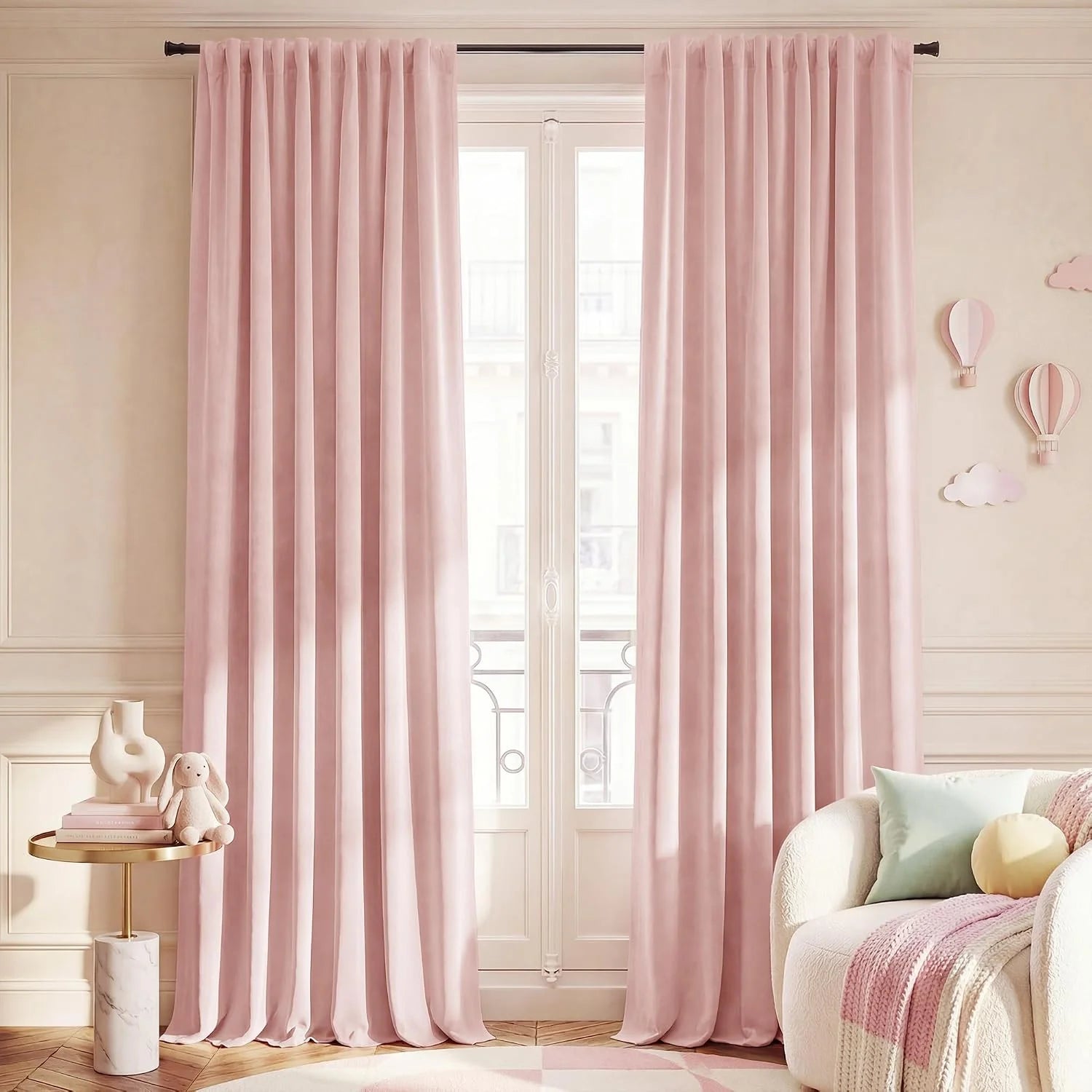 Blush pink velvet curtains hanging in a soft pastel kids room with cozy decor