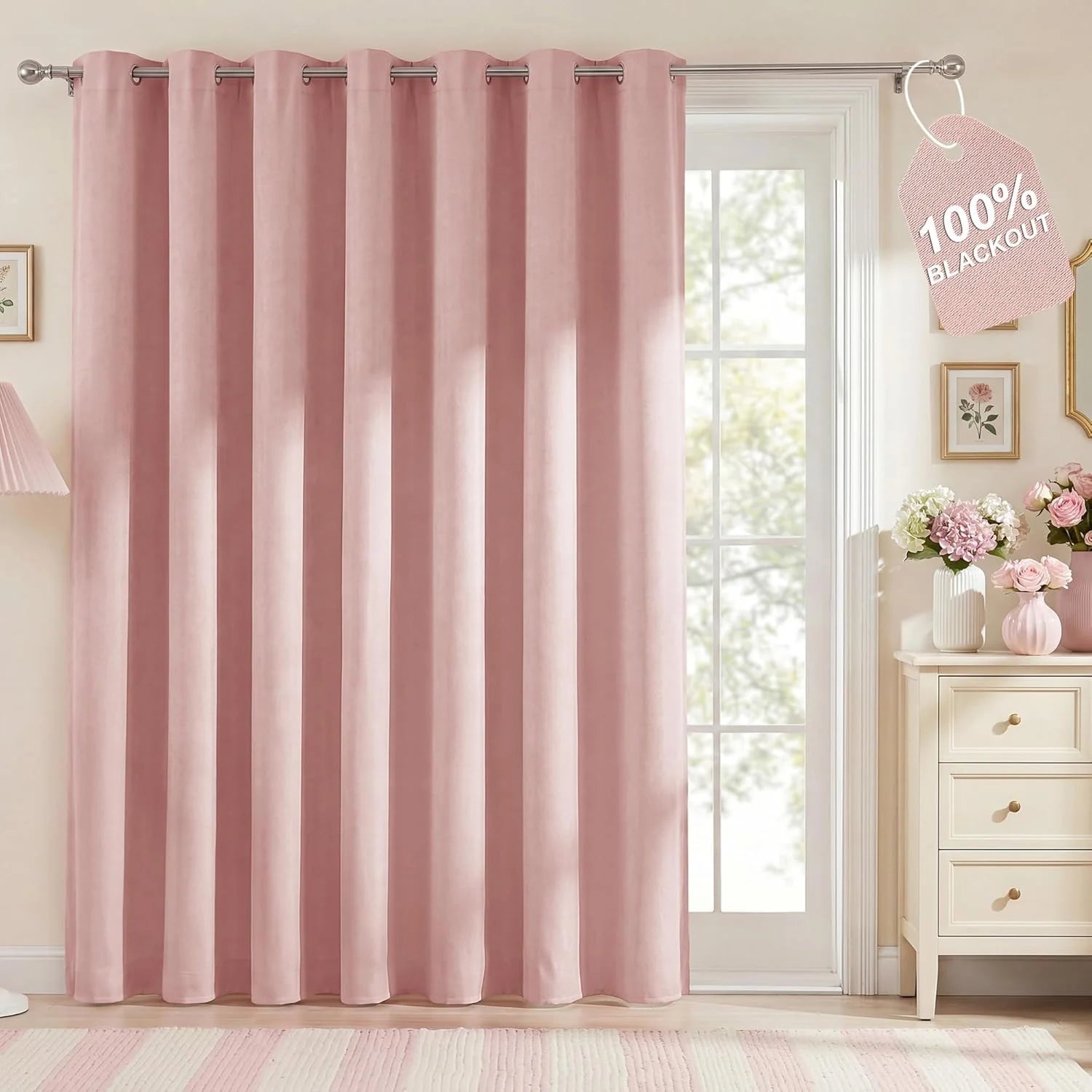 Blush pink velvet blackout curtain panel with silver grommets in a bright room setting