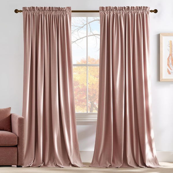 Blush velvet rod pocket curtains hanging on window, puddling on floor. Matching sofa visible.
