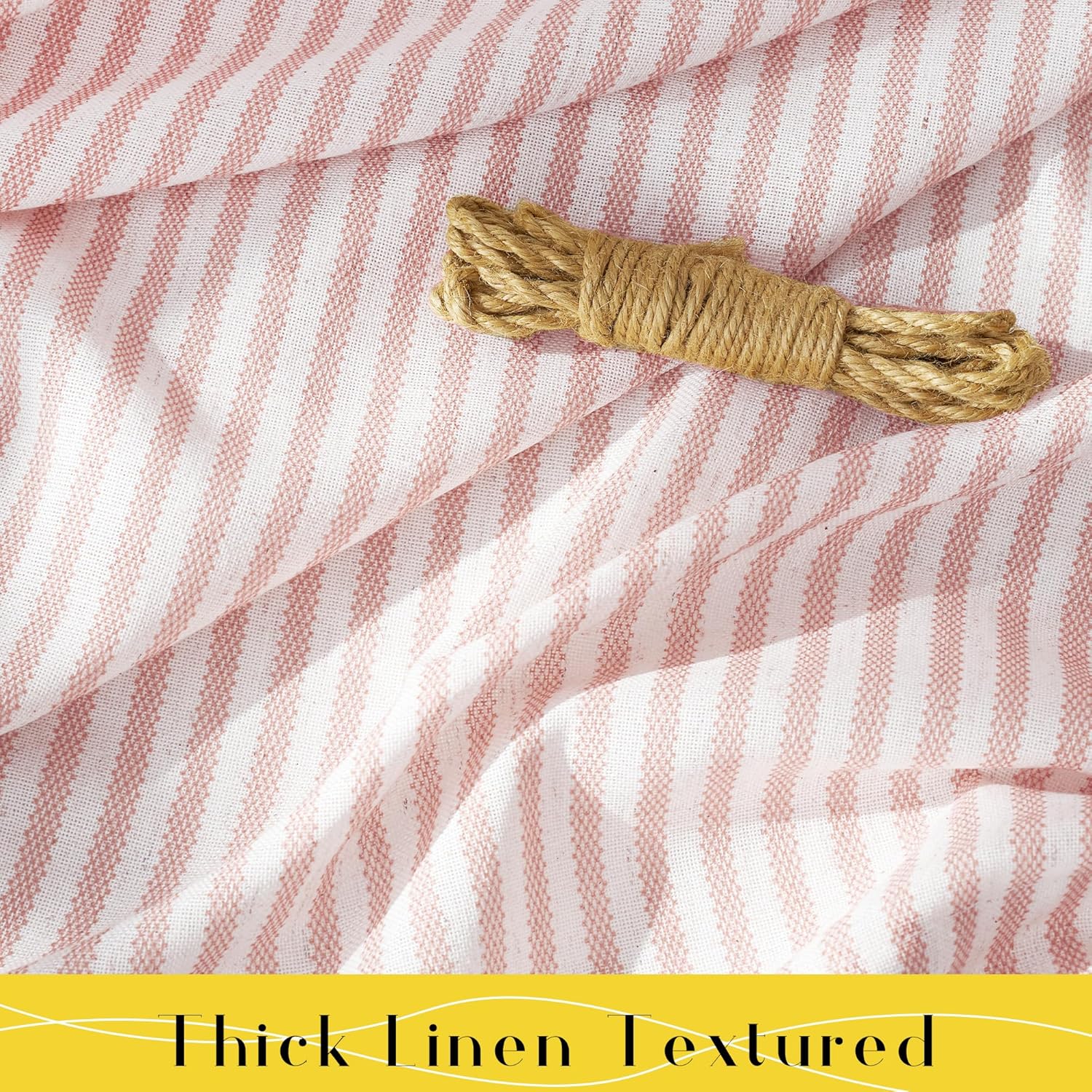Draped blush pink and white striped thick linen textured fabric, with a small roll of natural twine on top.
