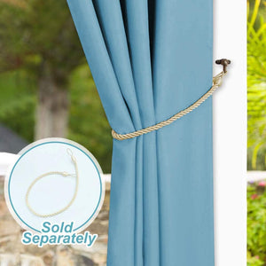 Braided gold rope tie-back holding a light blue curtain on a decorative bronze hook.