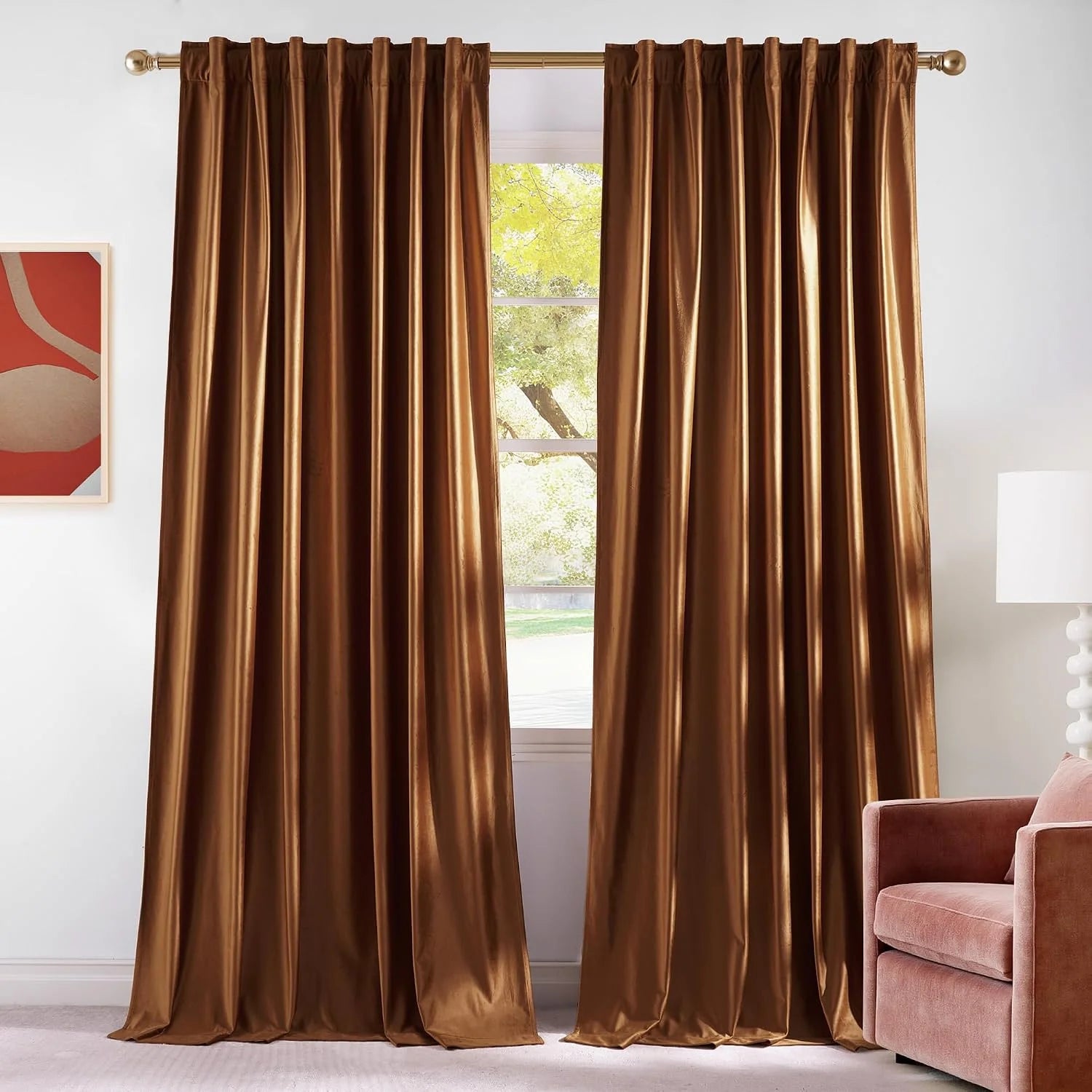 Bronze satin rod pocket curtains hanging on a gold curtain rod in a bright living room
