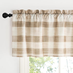 Brown and cream buffalo check plaid valance with a textured woven fabric, hung on a black rod above a window.