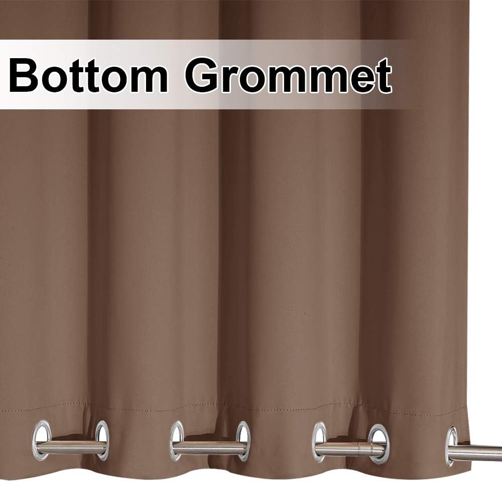 Close-up of a brown curtain panel with silver grommets along the bottom edge, threaded onto a metal rod.