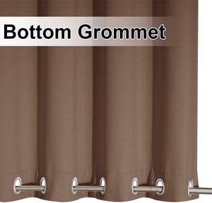 Close-up of a brown curtain panel with silver grommets along the bottom edge, threaded onto a metal rod.