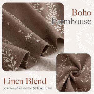 Close-up of brown linen blend fabric with a white boho farmhouse style floral and leaf pattern, showing soft draped texture.