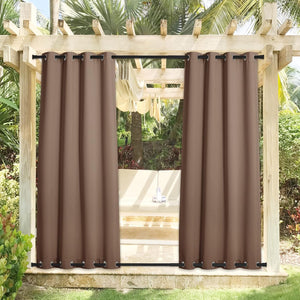 Brown outdoor grommet curtains hanging from a wooden pergola, framing an outdoor seating area.