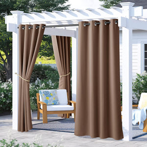 Brown grommet top outdoor curtains hanging on a white pergola over a patio with furniture, one set tied back.
