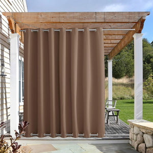 Brown outdoor privacy curtain with metal grommets hanging from a wooden pergola.