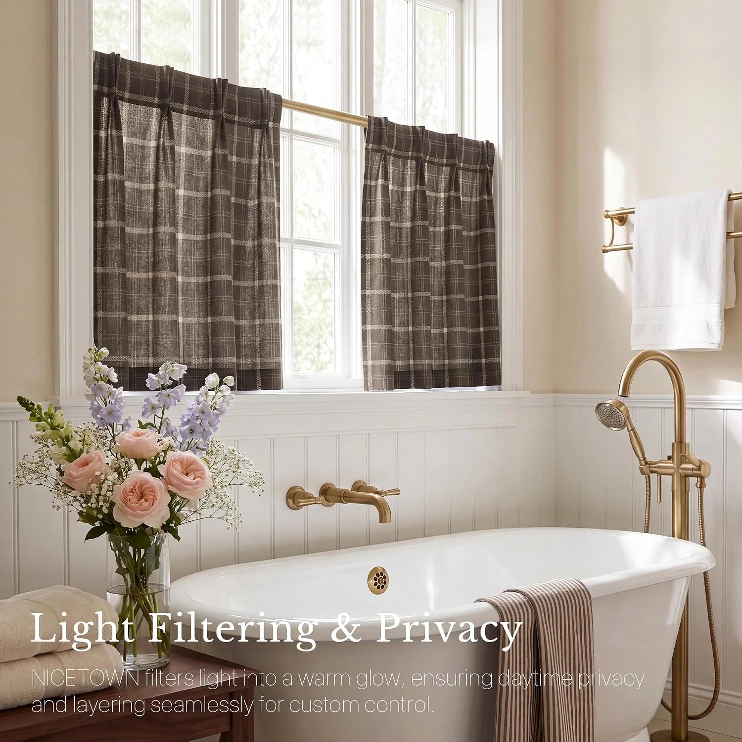 Brown plaid tier curtains over a bright bathroom window above a white bathtub