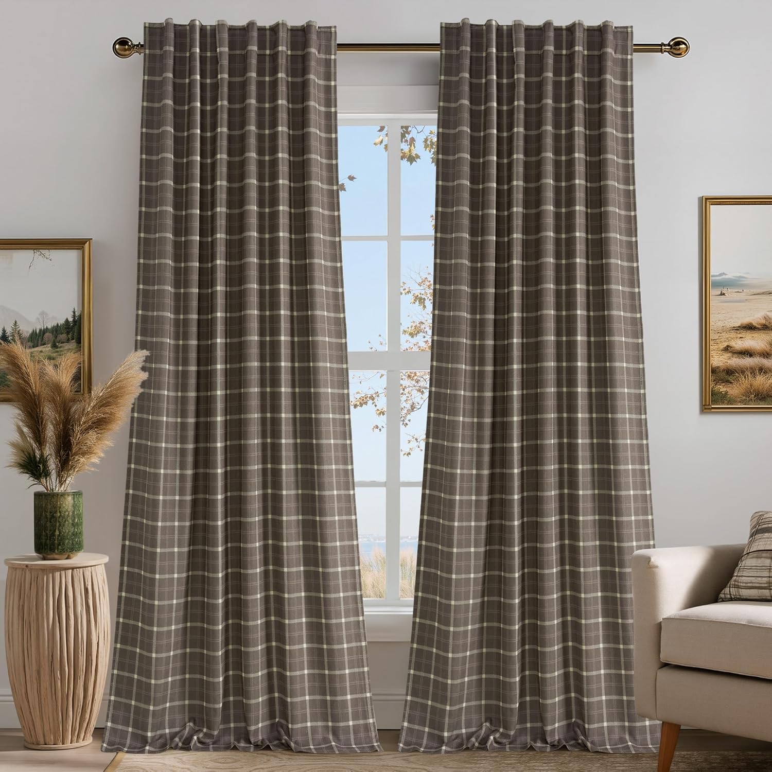 Two dark brown plaid window drapes with cream-colored checks, featuring a pleated top and hanging on a bronze rod.