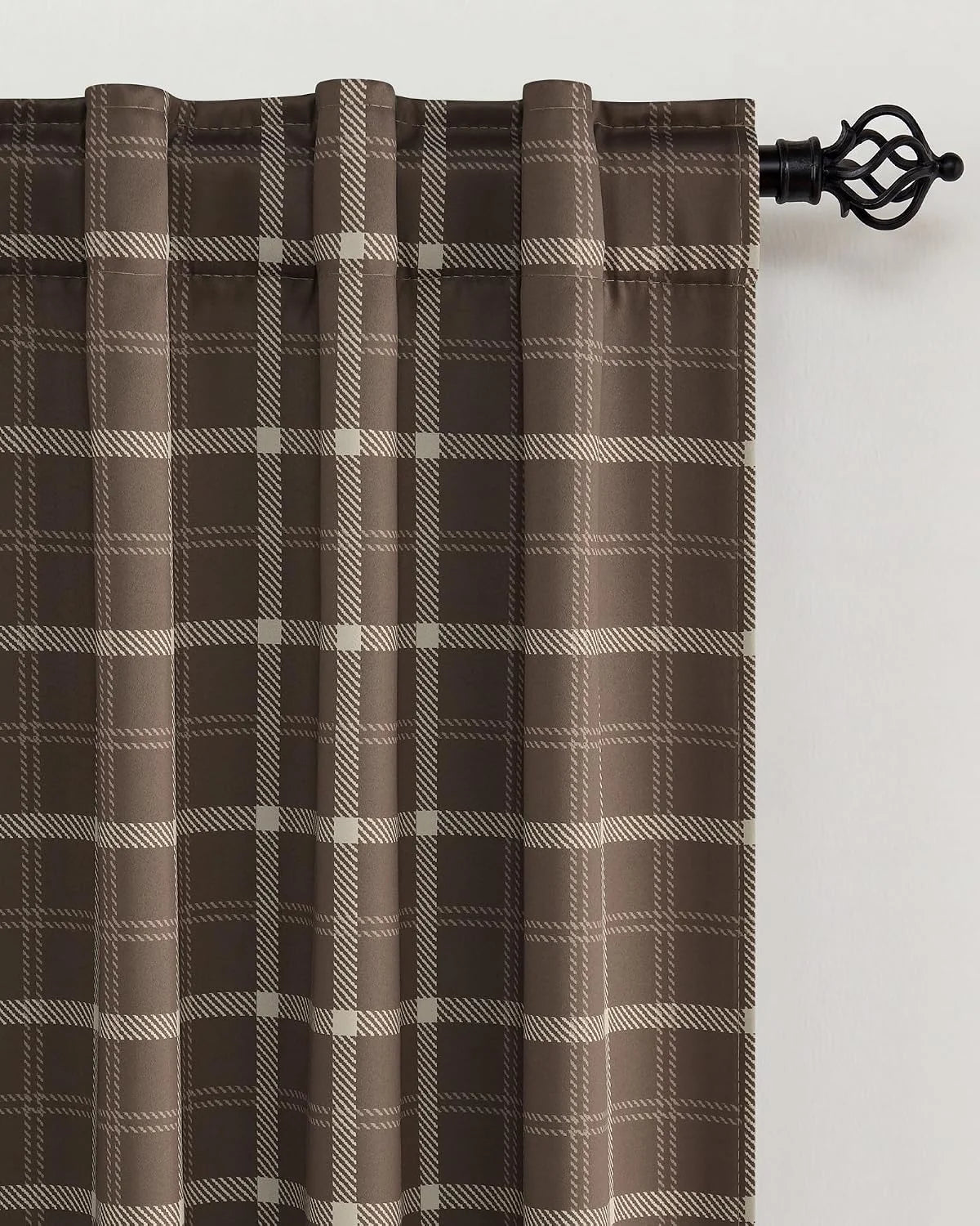 Brown plaid curtain panel with rod pocket hanging on a black decorative curtain rod