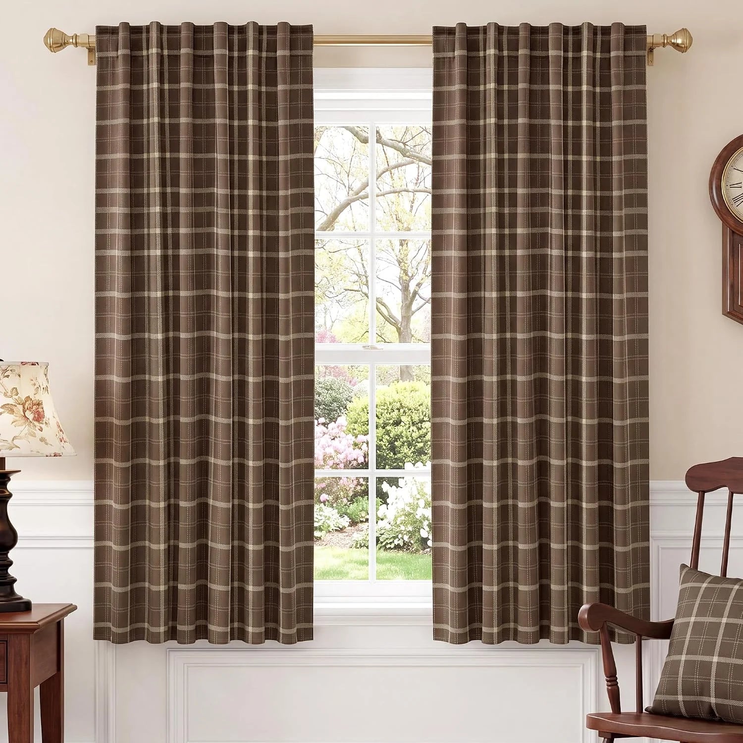 Brown plaid rod pocket curtains hanging on a brass rod in a traditional room