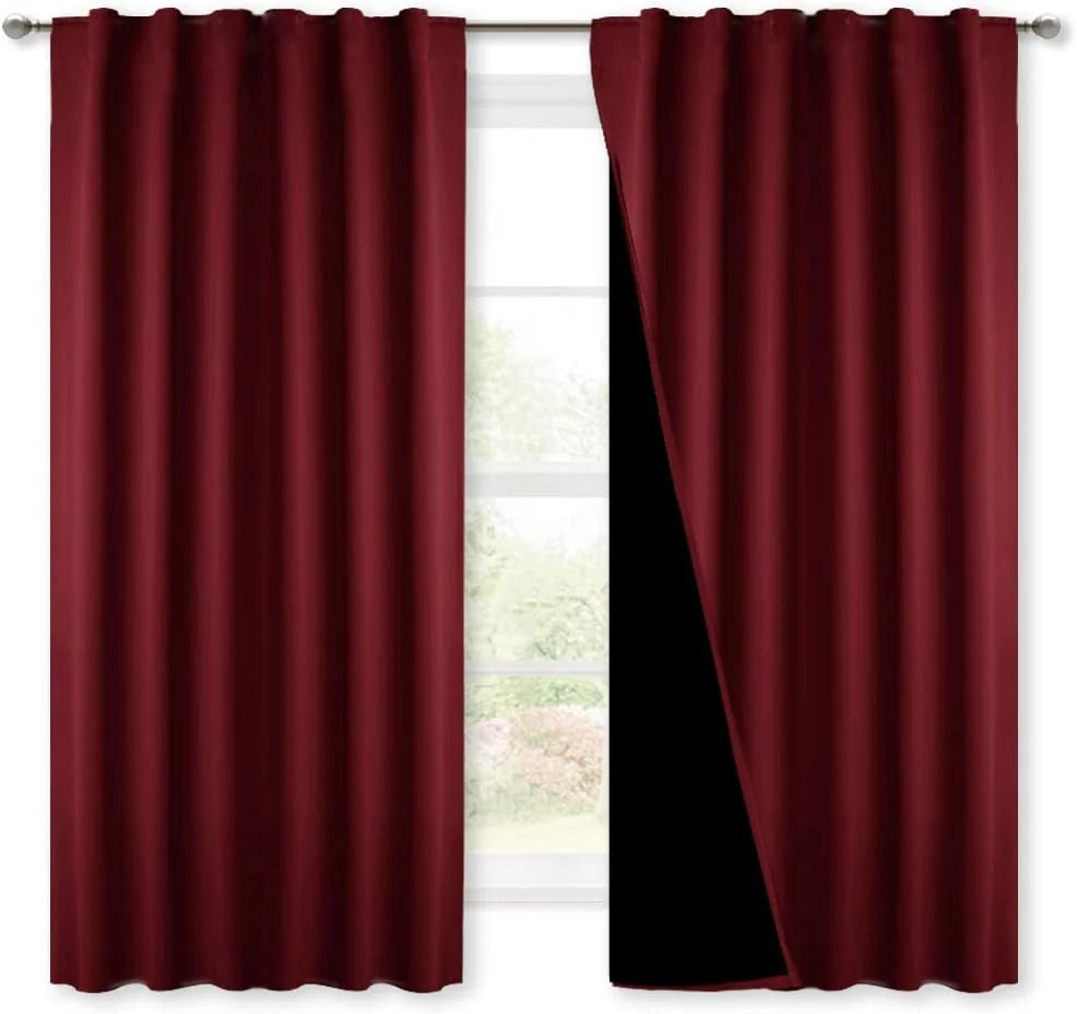 Burgundy rod pocket blackout curtains on a silver curtain rod with black lining