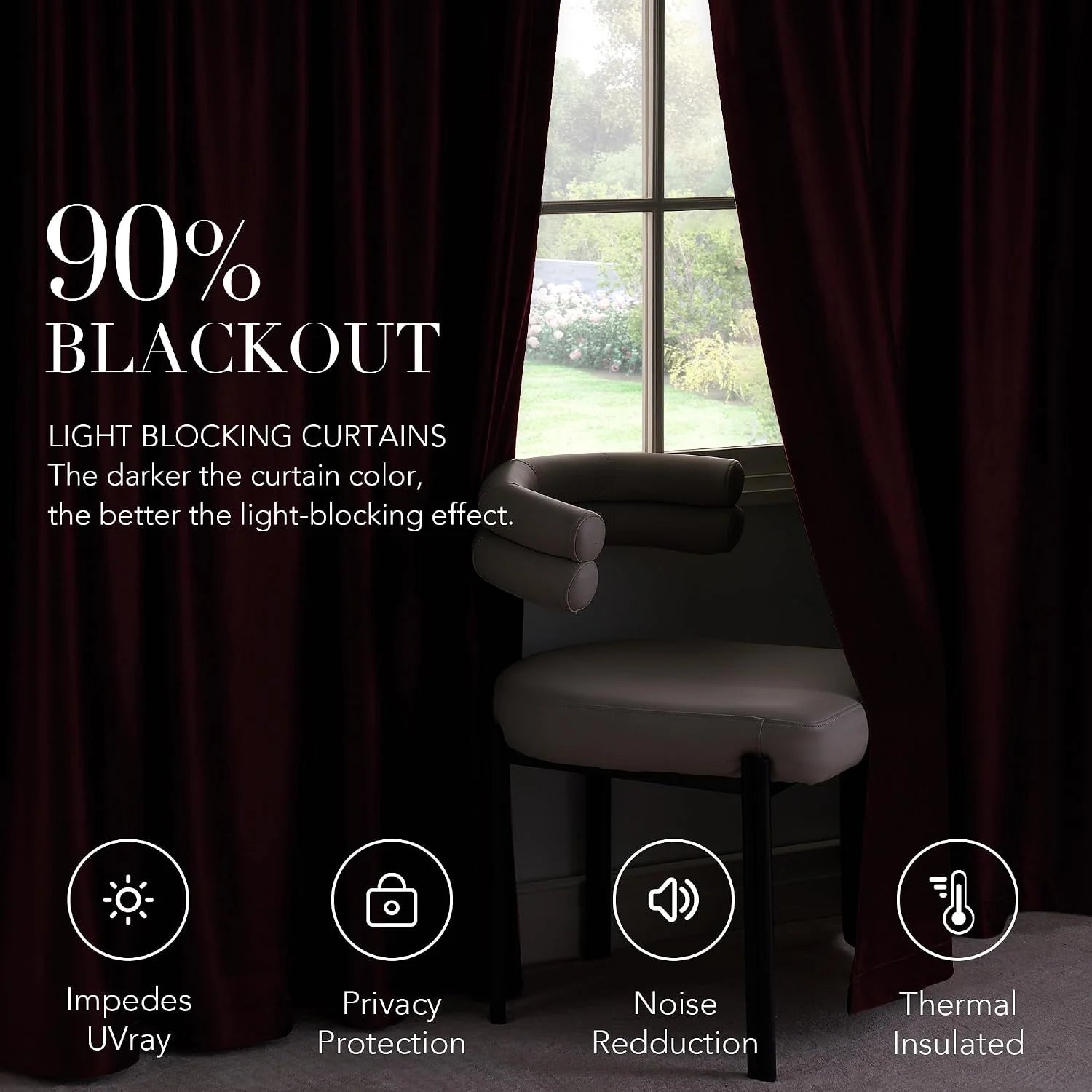 Dark burgundy blackout curtains framing a window beside a modern upholstered chair