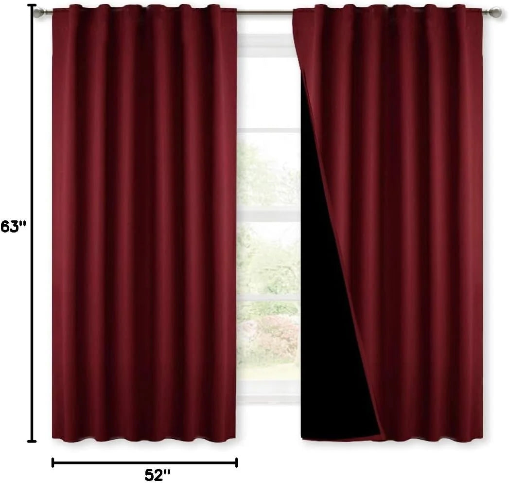 Burgundy blackout curtain panels on a silver rod, one panel pulled back to show black lining