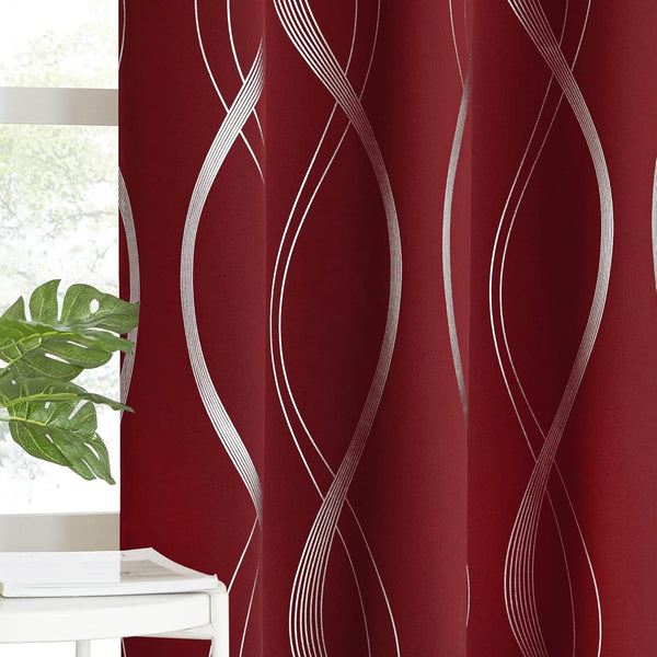 Modern burgundy curtains with striking silver wavy geometric pattern, seen next to a bright window with green plant.