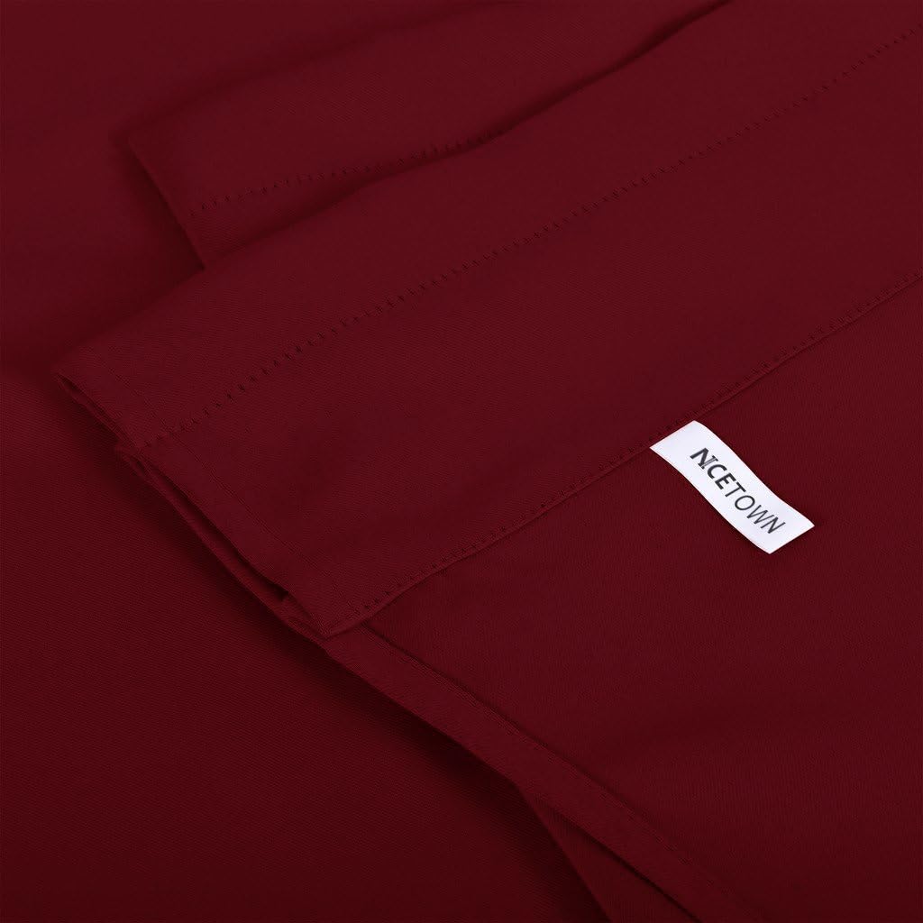 Close-up of a smooth, deep burgundy NICETOWN thermal blackout curtain panel with a visible stitched hem.