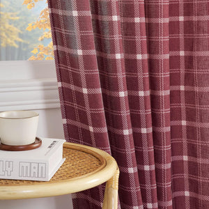 Burgundy and white plaid light-filtering window curtain with visible autumn leaves outside.