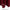 Close-up of rich burgundy curtain fabric showing smooth texture and neatly stitched bottom hem.