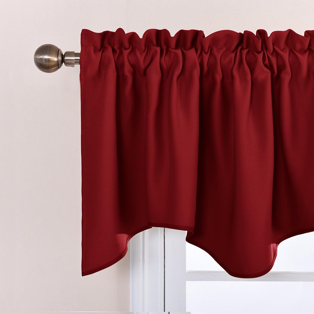 Deep burgundy rod pocket valance curtain with gathered top and decorative scalloped bottom edge hanging on a metal rod.
