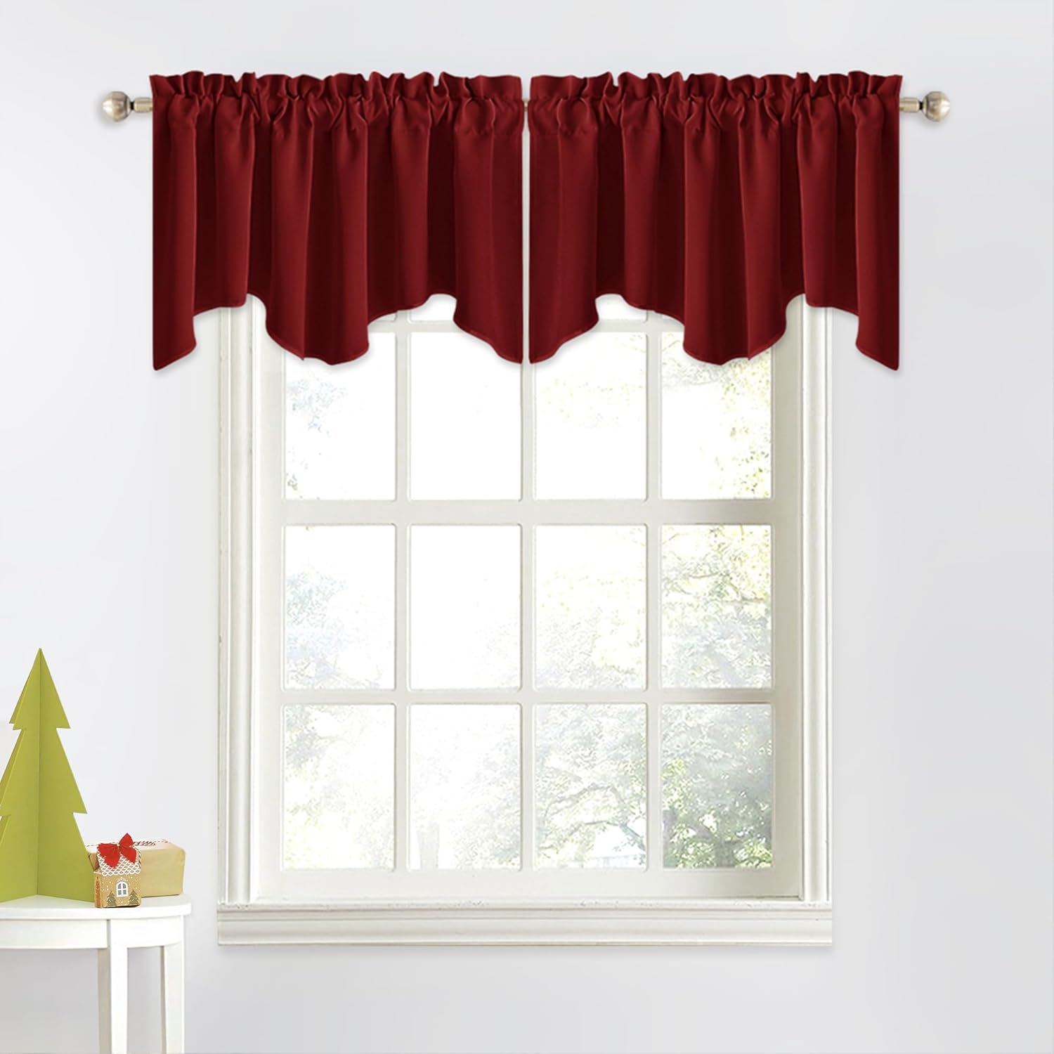 Deep burgundy scalloped valances with gathered rod pocket top, hanging on a silver rod over a white window.