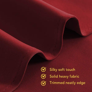 Close-up of deep burgundy fabric, highlighting its silky soft touch, heavy weight, and neatly trimmed edge.