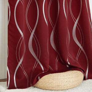 Rich burgundy curtain with elegant metallic silver wavy pattern, gracefully draping over a wicker pouf.