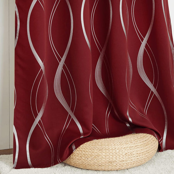 Rich burgundy curtain with elegant metallic silver wavy pattern, gracefully draping over a wicker pouf.
