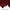 Close-up of a rich burgundy smooth fabric curtain panel with elegant soft folds and a neatly finished hem.