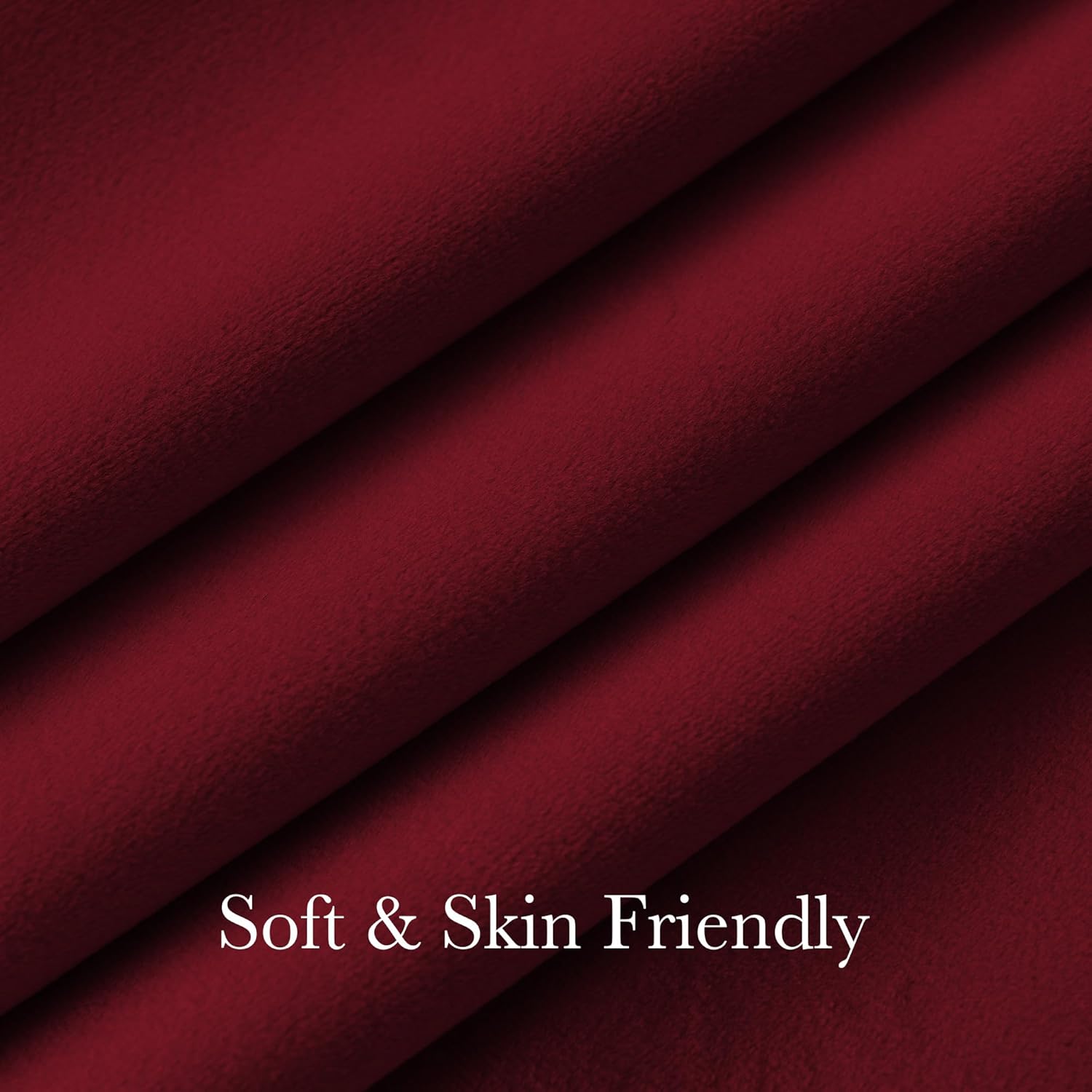 Close-up of a plush burgundy fabric with a soft, brushed texture and gentle folds, emphasizing its skin-friendly feel.
