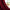 Burgundy solid curtain panel drapes, partially covering window with white vase and flowers.