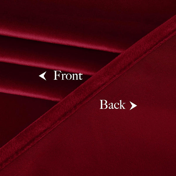 Deep red velvet curtain material closeup, revealing the soft front and woven blackout back.