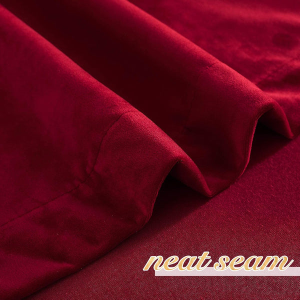 Rich burgundy velvet curtain fabric close-up, showcasing its soft texture and a neat seam.