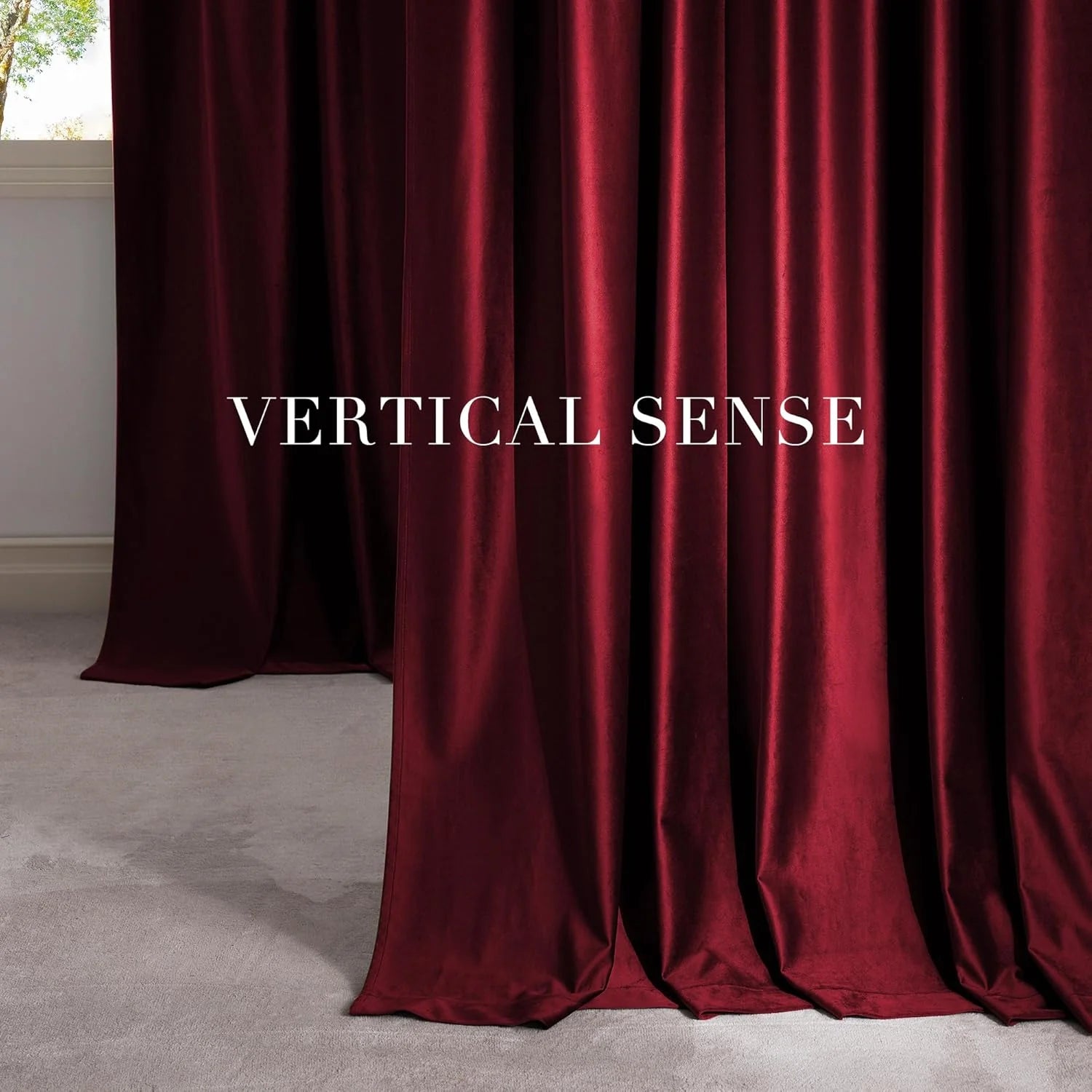 Deep burgundy velvet drapes with soft sheen pooling on a light carpet by a window