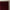 Burgundy velvet pinch pleat curtains hanging on a brass rod with ornate finial.
