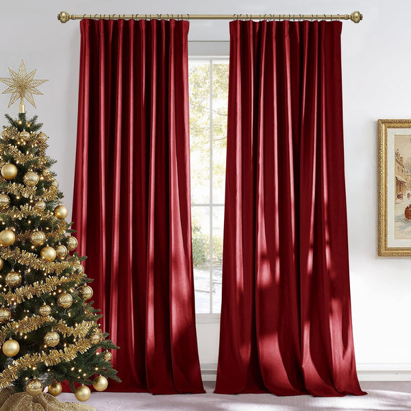 Pair of elegant burgundy velvet pleated curtains hung on a gold rod, framing a bright window.