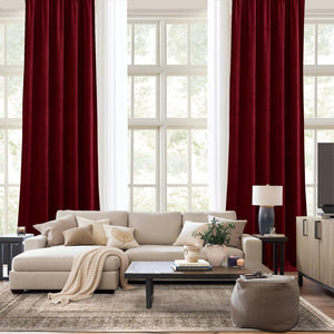 Rich burgundy velvet curtains with pleated tops, providing room darkening in a modern living room.