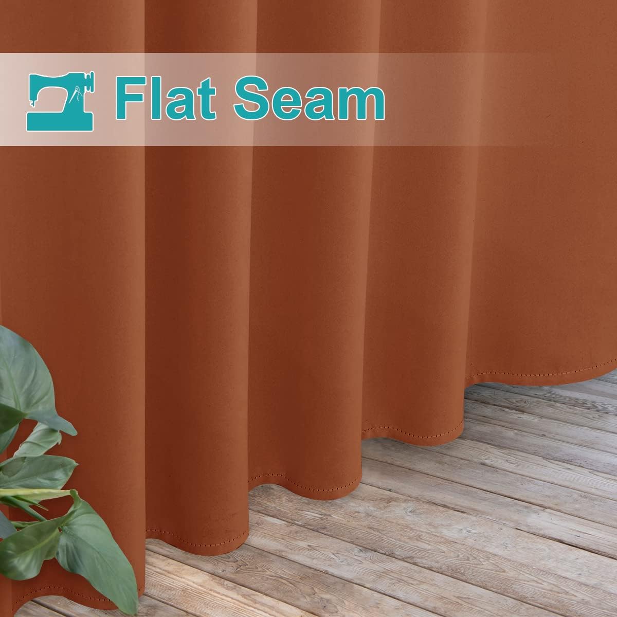 Burnt orange curtains with flat seams and decorative bottom hem stitching over light wood floor.