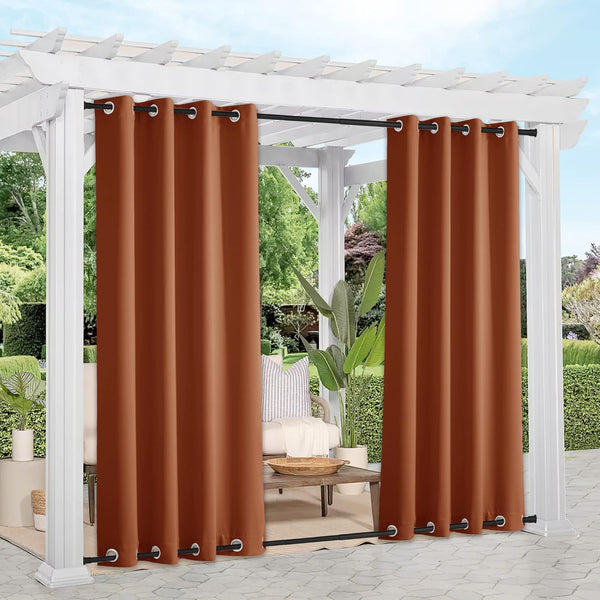 Burnt orange outdoor grommet curtains on a white pergola, perfect for patio privacy.